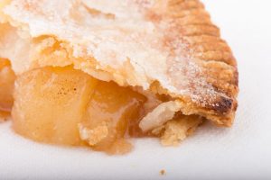 Tasty Pastry Tasty Treats: Close-up on Flaky Pie Crust with Apple Filling spilling out