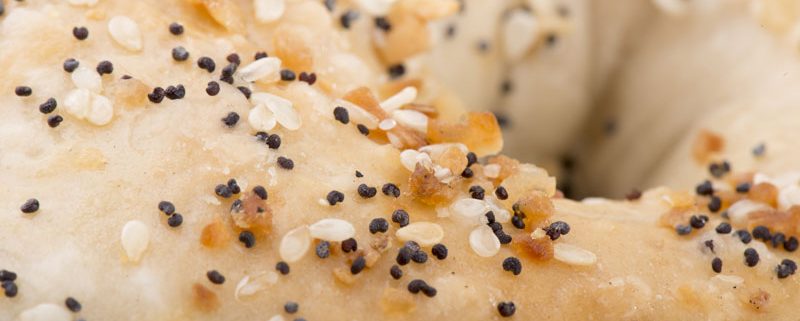 Tasty Pastry Tasty Treats: Close-up on Bagel with poppyseeds and sesame seeds