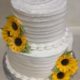 Tasty Pastry Custom Cakes: Two-tier cake with white icing & decorated with edible sugar sunflowers