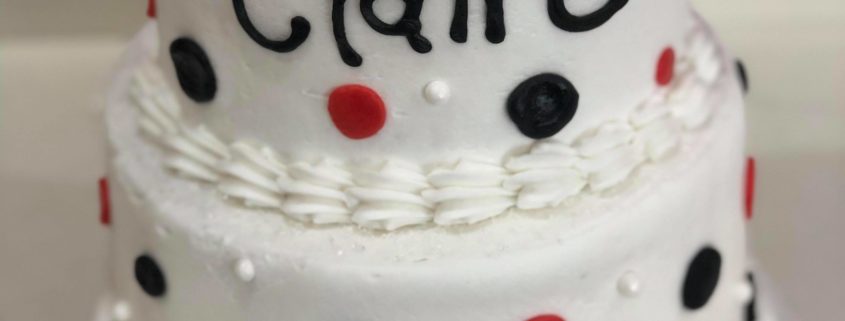 Tasty Pastry Custom Cakes: Two-tier birthday cake with white icing and red/black polka dot decor