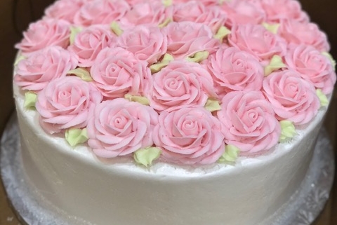 Tasty Pastry Custom Cakes: Round 1-tier cake with white icing and covered in pink icing roses